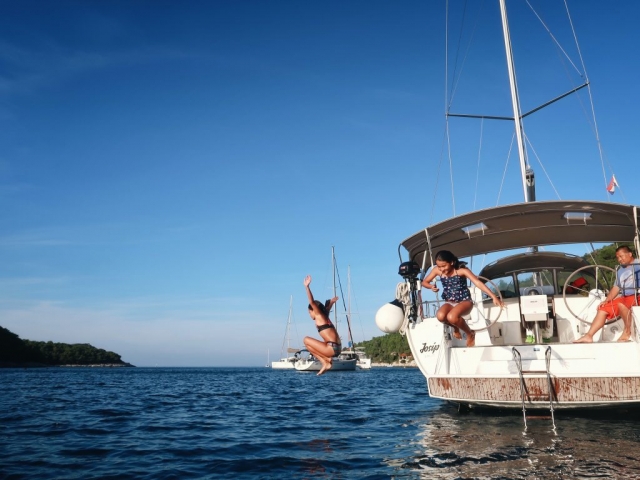 Kids enjoying summer activities at the sailing boat at the island of Hvar
