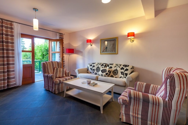 Living room with open French door and garden view