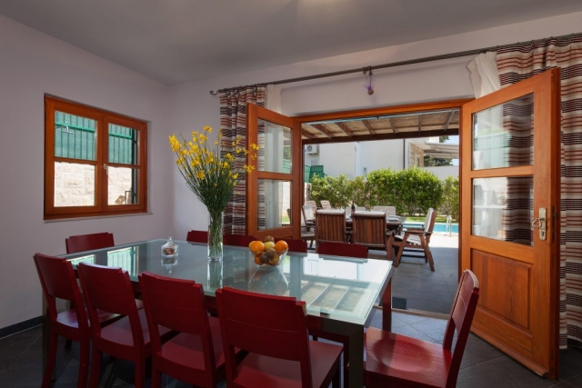 Dining room with open French door and the view at the swimming pool